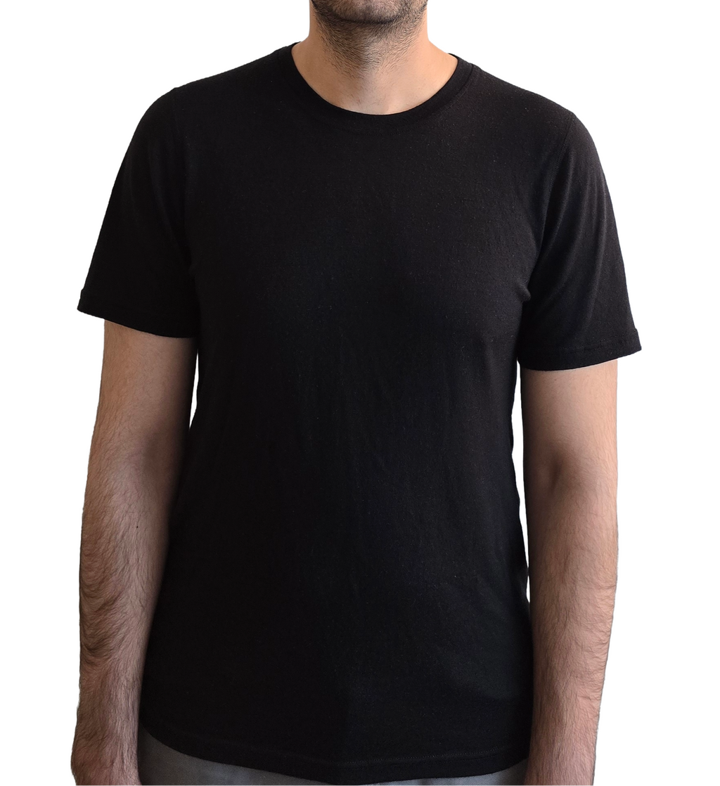 Man wearing a plain black t-shirt on a white background